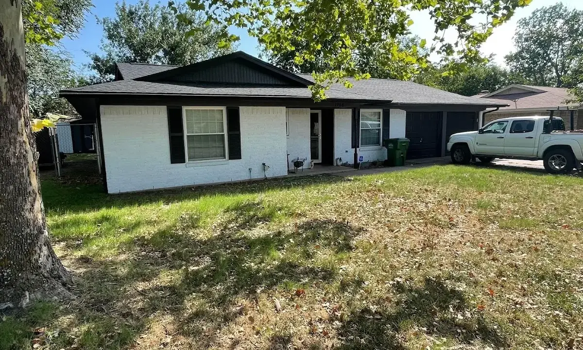 Professional roofing crew working on a residential roof in Cheval